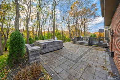 View of patio / terrace with a hot tub and a wooden deck