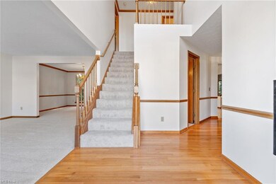 Staircase featuring light hardwood flooring