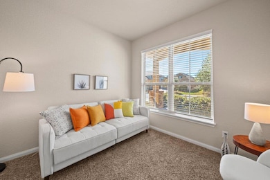 Sitting room with carpet flooring and baseboards