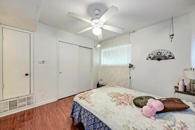 Bedroom featuring wood finished floors, a closet,