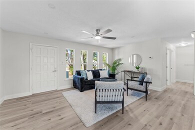 Bright open-concept living and kitchen area featuring brand new luxury vinyl plank flooring
