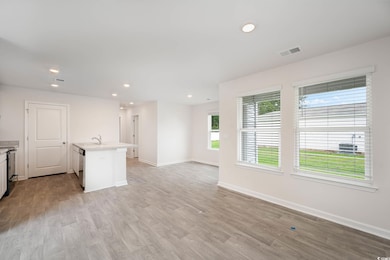 Unfurnished living room featuring light wood-type 