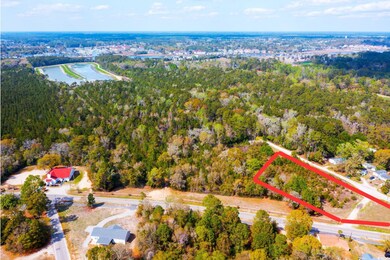 Birds eye view of property with a water view and a