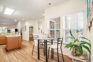 Dining room featuring light wood-type flooring, recessed lighting, and lofted ceiling
