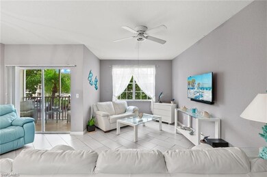 Tiled living room featuring ceiling fan and baseboards