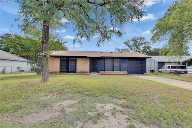 Ranch-style house with a garage, concrete drivewa