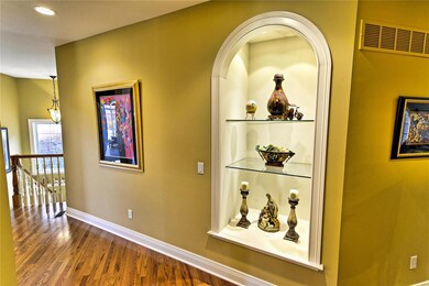 Beautiful hardwood floors flow from the grand entr