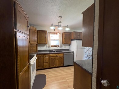 Kitchen featuring white fridge, dishwasher, stove,