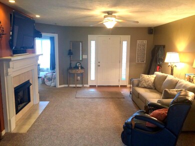 Another view of livingroom with wonderful fireplace and TV wiring above.