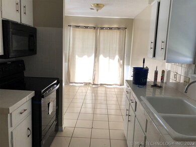 Kitchen has black appliances including built in mi