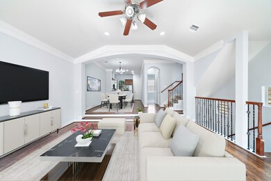 Well-lit living room with high ceiling, ceiling fa