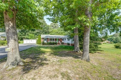 Single story home with a garage and a front yard