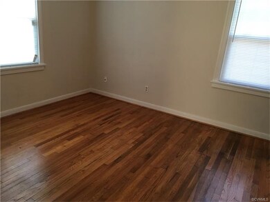 Bedroom with refinished hardwood floors