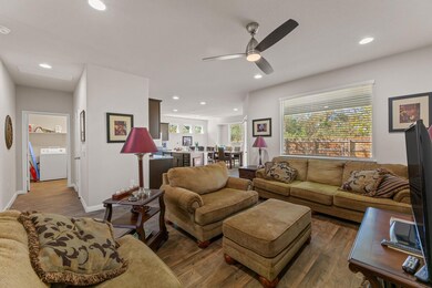 Living area featuring recessed lighting, wood finished floors, washer / dryer, and ceiling fan