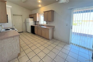 Kitchen featuring ceiling fan, light tile patterne