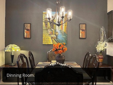 Dining area featuring a textured wall and a chand