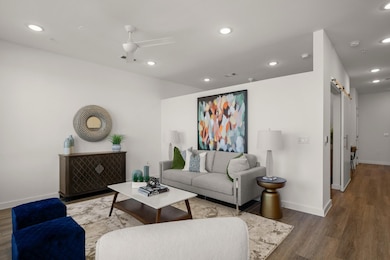 Living area with baseboards, recessed lighting, a