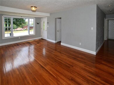 Gleaming refinished hardwood floors in the dining 