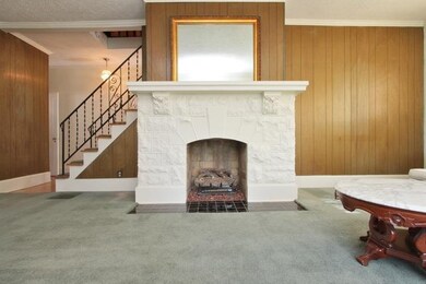 The living room features a working fireplace with 