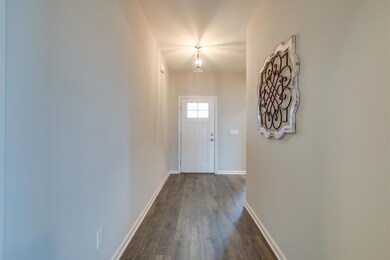 Hall from foyer seperates secondary bedrooms and bath from master and living space
