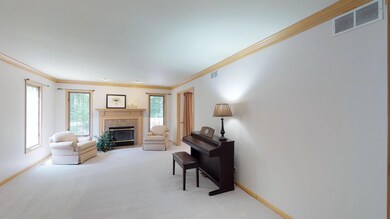 Spacious room with marble faced fireplace and a vi