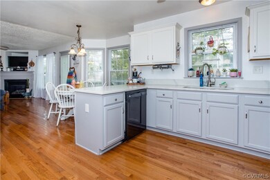 Kitchen with decorative light fixtures, white cabi