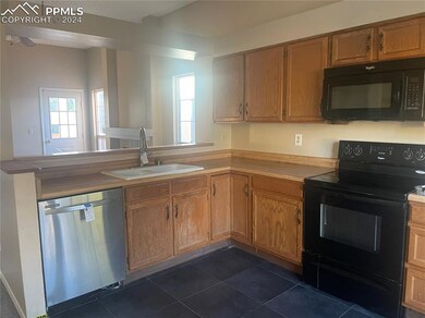 The kitchen overlooks the great room and has ample