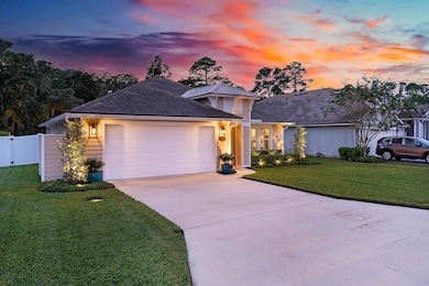 View of front facade with concrete driveway, a garage, and roof with shingles