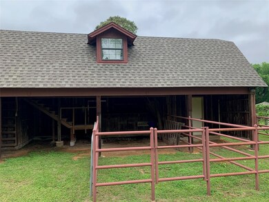 View of horse barn with an outdoor structure