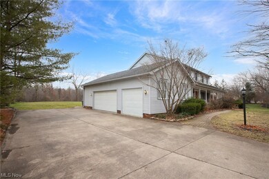 View of property exterior featuring a garage and a lawn