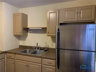 Kitchen with stainless steel refrigerator