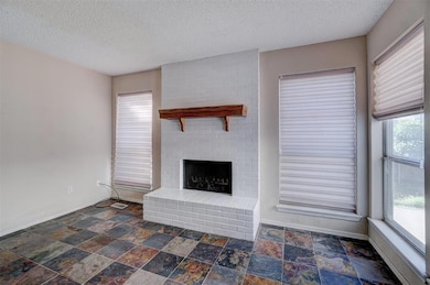 Unfurnished living room with a textured ceiling, a