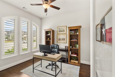 Located right off the Foyer, behind two glass-paned doors, sits this elegant Study, equipped with extra-wide baseboards, 5-blade ceiling fan, and a trio of front facing windows adorned with plantation shutters.