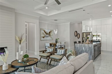 Living room featuring beamed ceiling, ornamental m