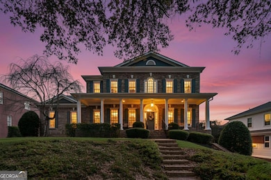 Stunning twilight view showcasing the home's stately architecture, inviting front porch, and beautifully illuminated windows.