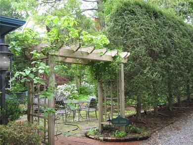 From the driveway you can pass under the trellis a