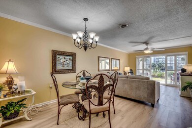 Dining space with a textured ceiling, ceiling fan 