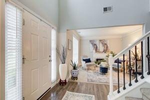 Entryway with stairs and wood finished floors