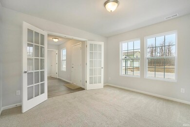 The den has ample lighting, French door entry and 