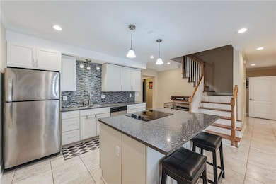 Kitchen featuring a sink, stainless steel applianc