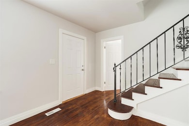 Foyer with hardwood / wood-style floors and stairway