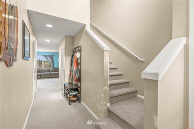 Entry way looking into first floor of home and stairway up to the three bedrooms.