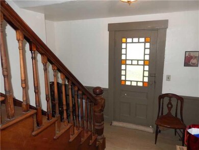 Foyer. Stained glass door opens to...