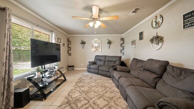 A spacious living room with a large window greets you as you enter.