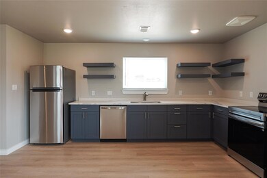 Kitchen featuring appliances with stainless steel
