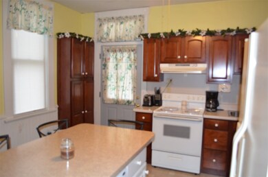 Our kitchen accesses the back door and covered pat
