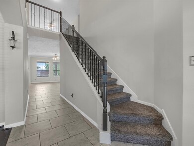 This is an elegant entryway with a curved staircas