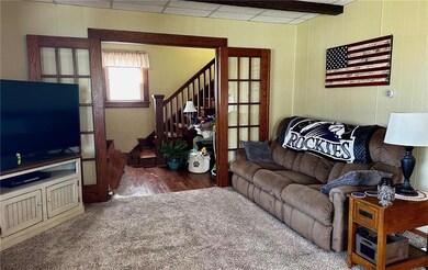 French doors open to the living room