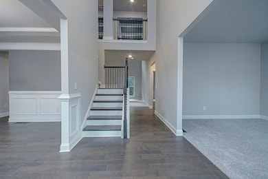 Stairway featuring ornamental molding, baseboards, and wood finished floors