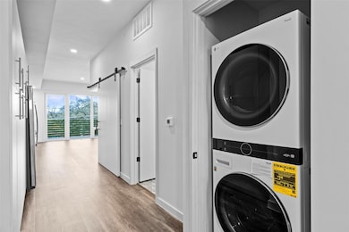 Laundry area with stacked washer and clothes drye